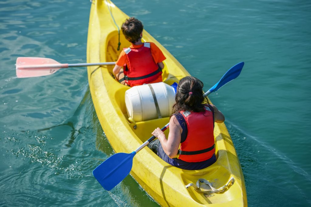 Upper shot of two young people canoeing in the lake